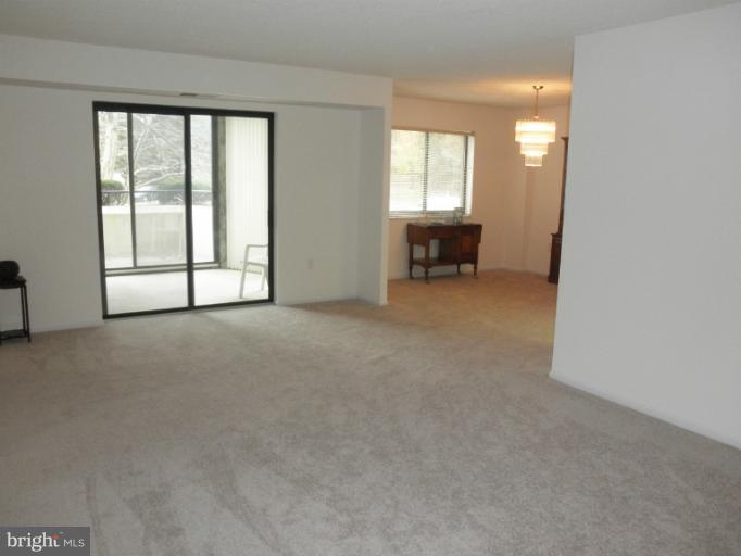 15100 Interlachen Drive, Unit 4111 Silver Spring, MD 20906 - Photo 4 of 28 Living Room with Slider to Sunroom and Balcony