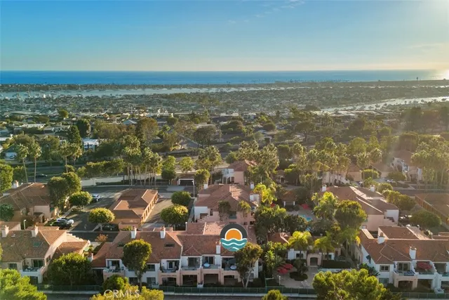 an aerial view of residential building and lake