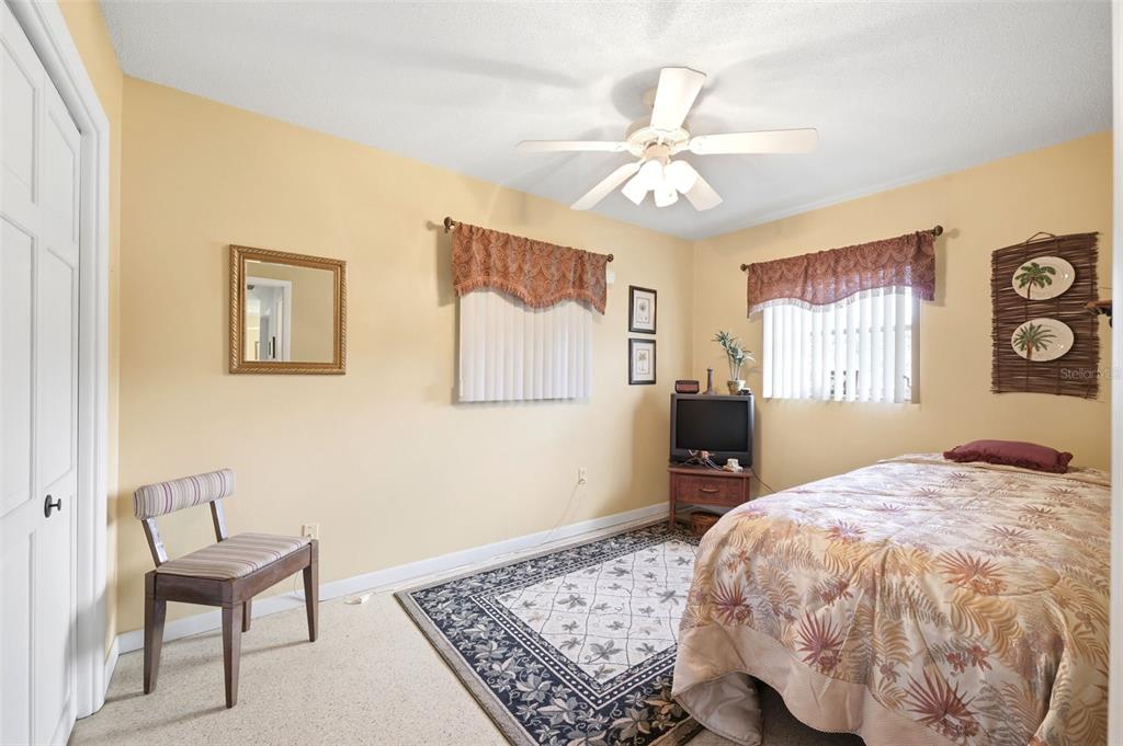 1830 South Mandarin Terrace Inverness, FL 34450 - Photo 16 of 47 a bedroom with a large bed and a chandelier