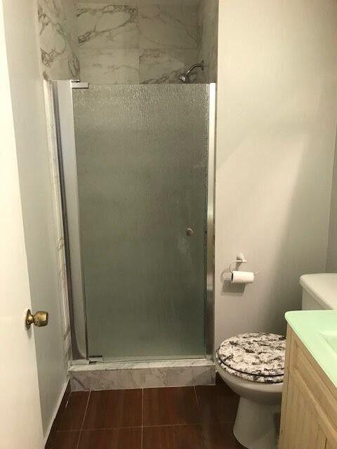 3405 Poolside Drive Greenacres, FL 33463 - Photo 19 of 32 a bathroom with a sink a toilet and shower