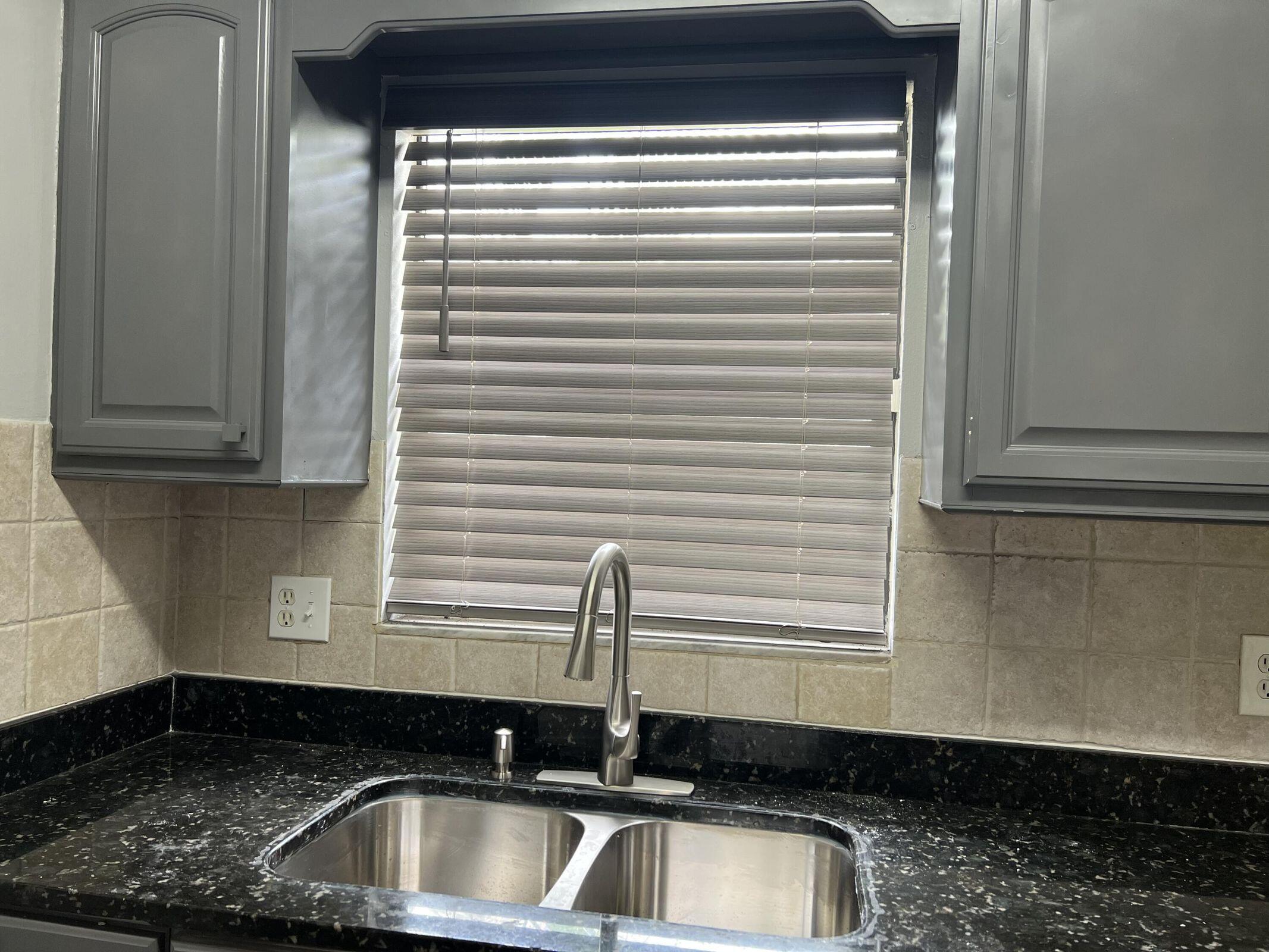 3405 Poolside Drive Greenacres, FL 33463 - Photo 26 of 32 a kitchen with a sink and a window