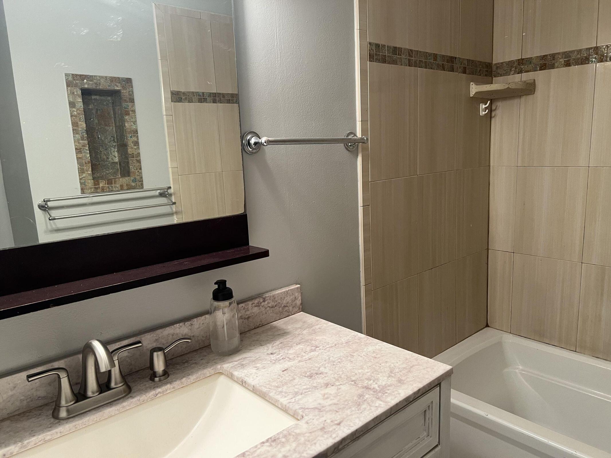 3405 Poolside Drive Greenacres, FL 33463 - Photo 29 of 32 a bathroom with a granite countertop sink and a bathtub