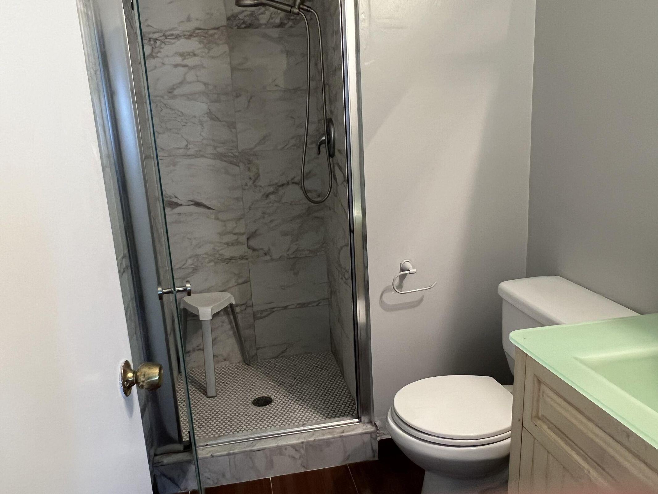 3405 Poolside Drive Greenacres, FL 33463 - Photo 9 of 32 a white toilet sitting next to a bathroom sink