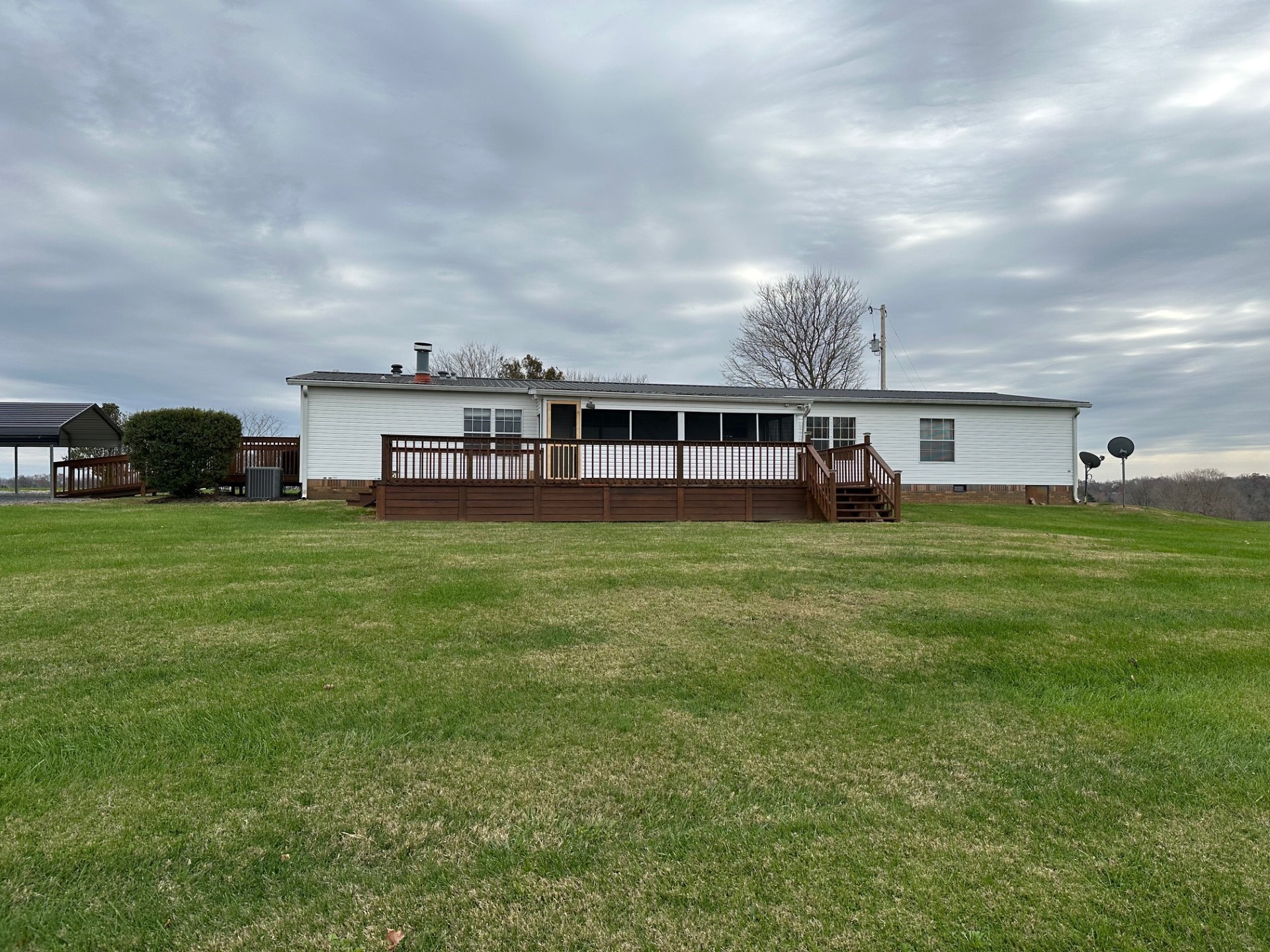 6448 Payne Road Portland, TN 37148 - Photo 3 of 28 a view of a house with a big yard and large trees