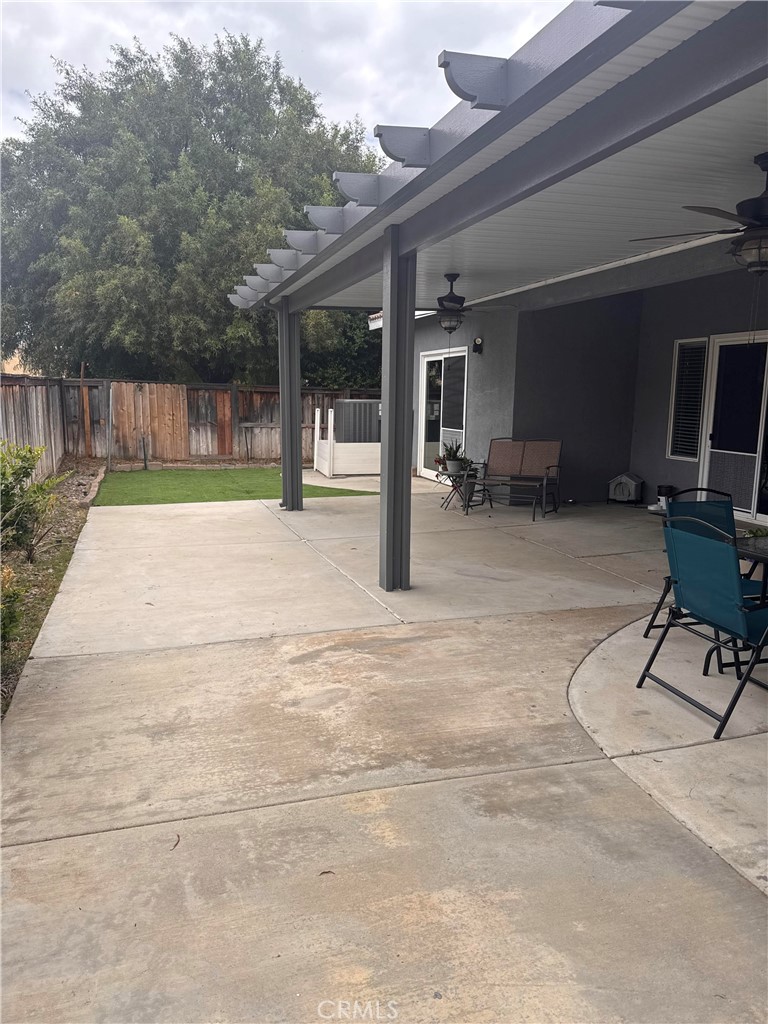 1251 Stepstone Court Hemet, CA 92545 - Photo 41 of 51 a view of a backyard with seating space and wooden fence
