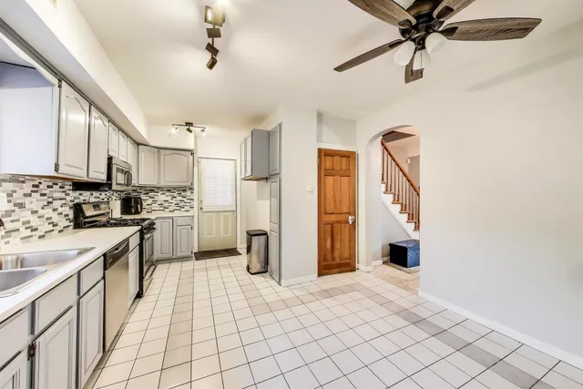 a kitchen with a refrigerator a stove top oven a sink and a refrigerator