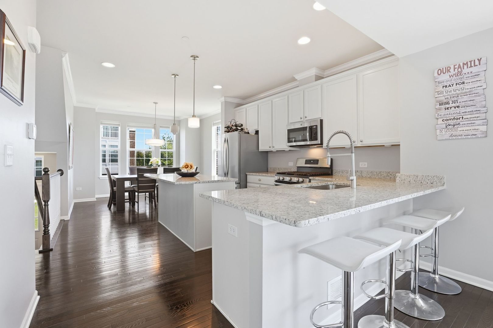 2925 Madison Drive Naperville, IL 60564 - Photo 3 of 37 a kitchen with stainless steel appliances granite countertop a stove top oven a sink dishwasher a refrigerator and white cabinets with wooden floor