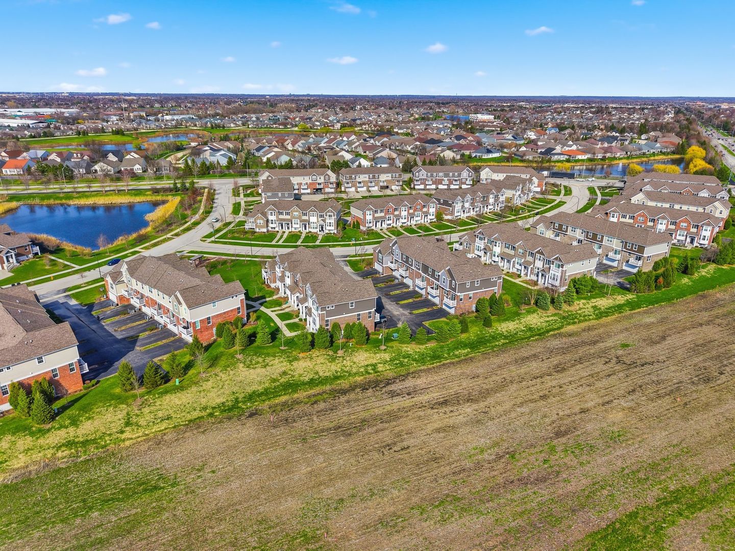 2925 Madison Drive Naperville, IL 60564 - Photo 36 of 37 an aerial view of a city with lots of residential buildings ocean and mountain view in back