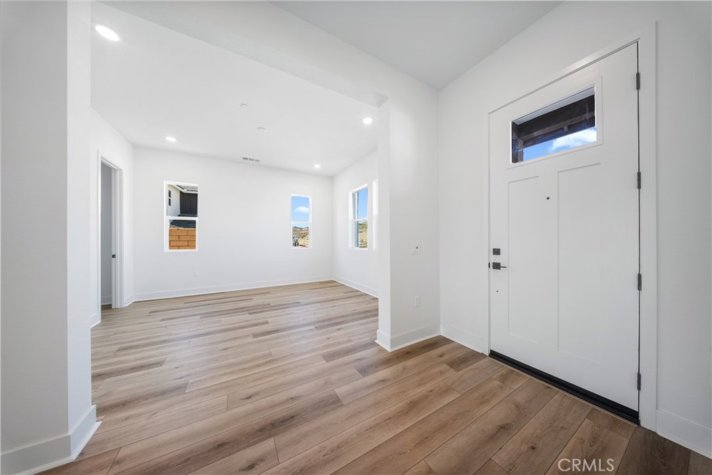 28632 Old Spgs Road Castaic, CA 91384 - Photo 13 of 70 a view of an empty room with wooden floor and a window