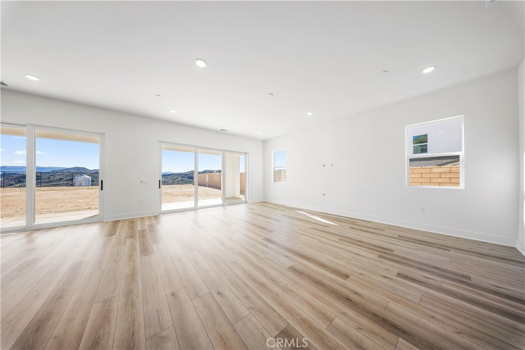 28632 Old Spgs Road Castaic, CA 91384 - Photo 25 of 70 an empty room with wooden floor and windows