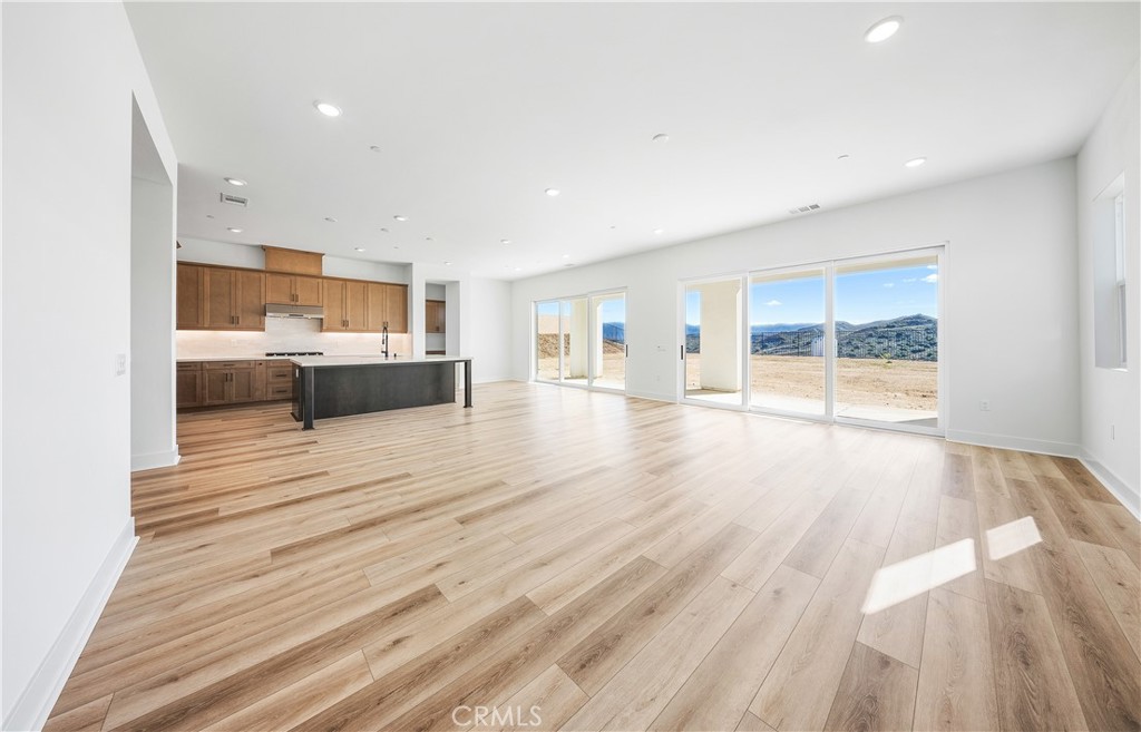 28632 Old Spgs Road Castaic, CA 91384 - Photo 26 of 70 a view of a living room a kitchen with stainless steel appliances wooden floor and view living room