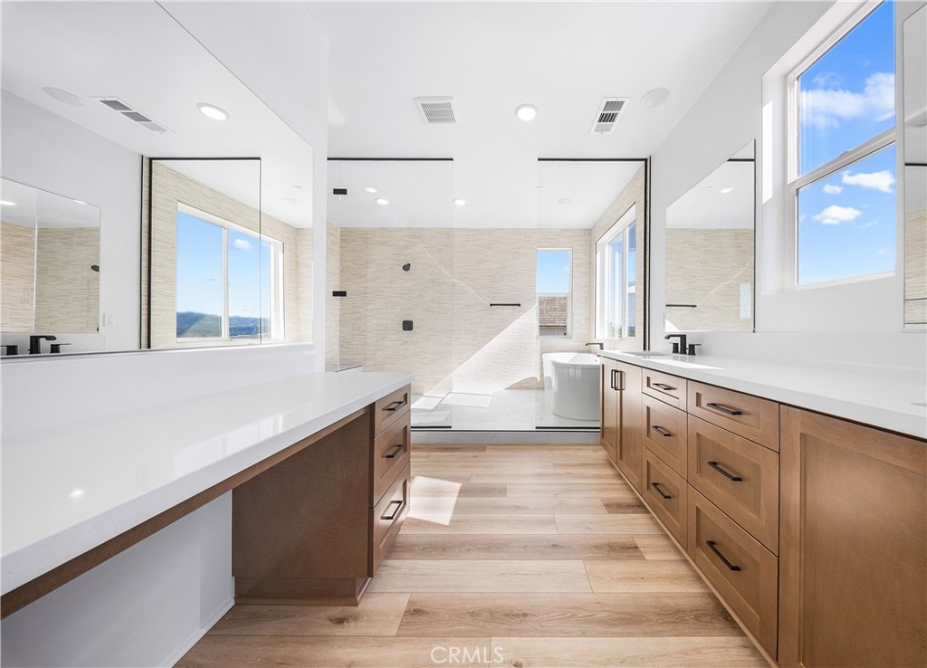 28632 Old Spgs Road Castaic, CA 91384 - Photo 58 of 70 a large white kitchen with a large counter top space a sink and stainless steel appliances