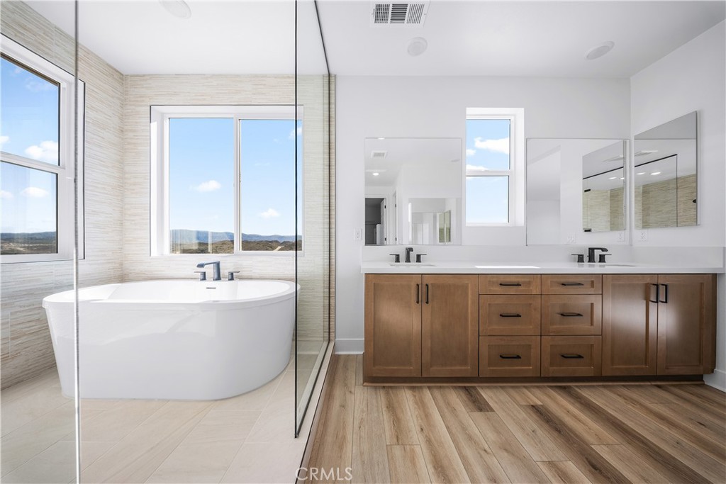 28632 Old Spgs Road Castaic, CA 91384 - Photo 63 of 70 a spacious bathroom with a tub sink and mirror