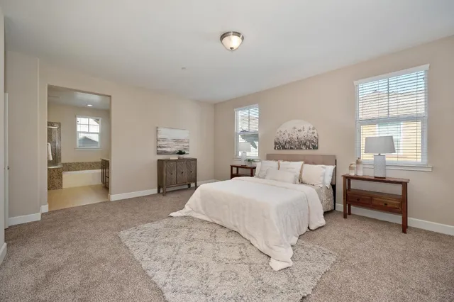 a bedroom with a large bed and a chandelier