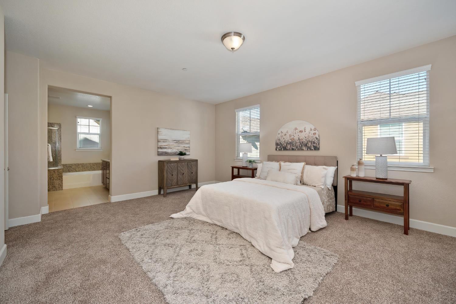 908 Lyon Place Roseville, CA 95747 - Photo 18 of 31 a bedroom with a large bed and a chandelier