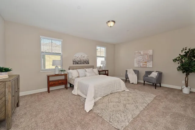 a bed room with a bed and a chair