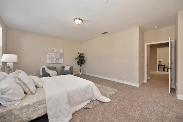 a bedroom with a bed and a lamp