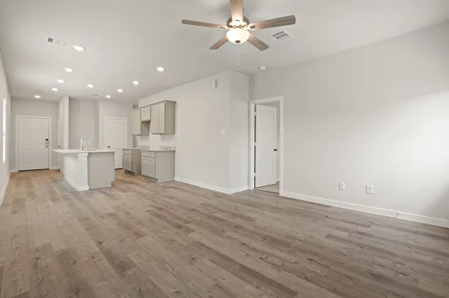 a view of a kitchen with a dishwasher and white cabinets