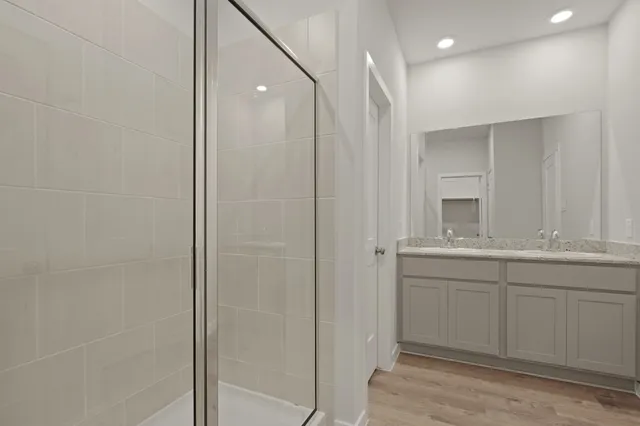 a bathroom with a double vanity sink and a mirror