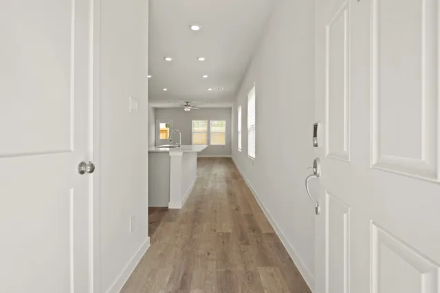 a view of a hallway with wooden floor