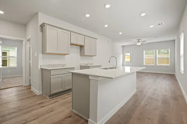 a kitchen with granite countertop white cabinets and white appliances