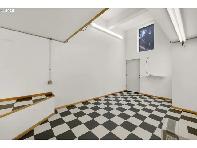 a bedroom with a black and white checkered floor