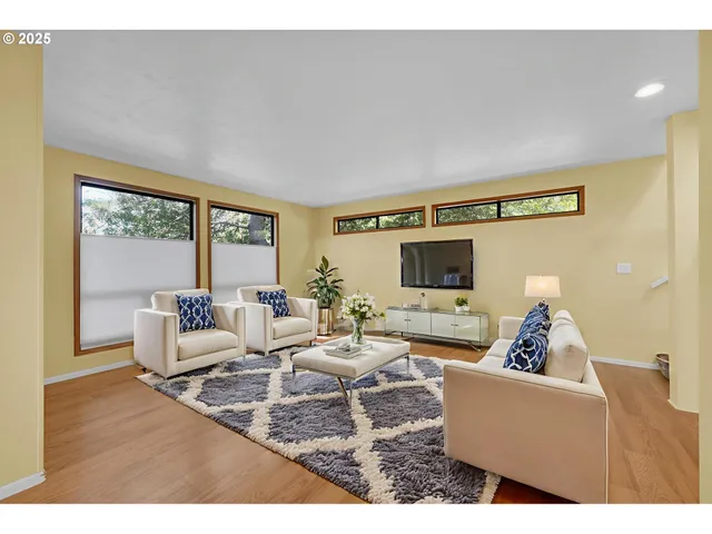 a living room with couches and a flat screen tv
