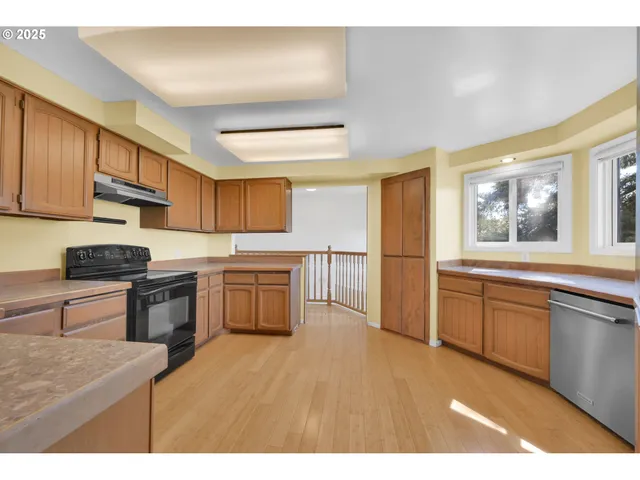 a kitchen with granite countertop a stove top oven sink and cabinets