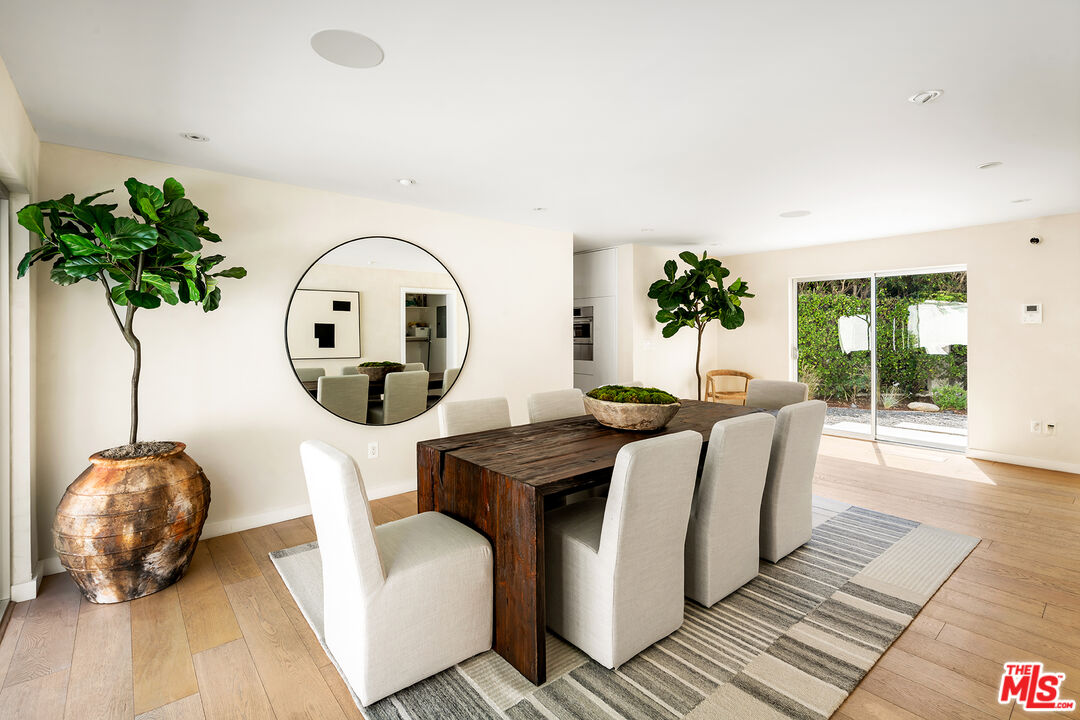 1600 North Kings Road Los Angeles, CA 90069 - Photo 11 of 37 a living room with furniture a potted plant and a large window