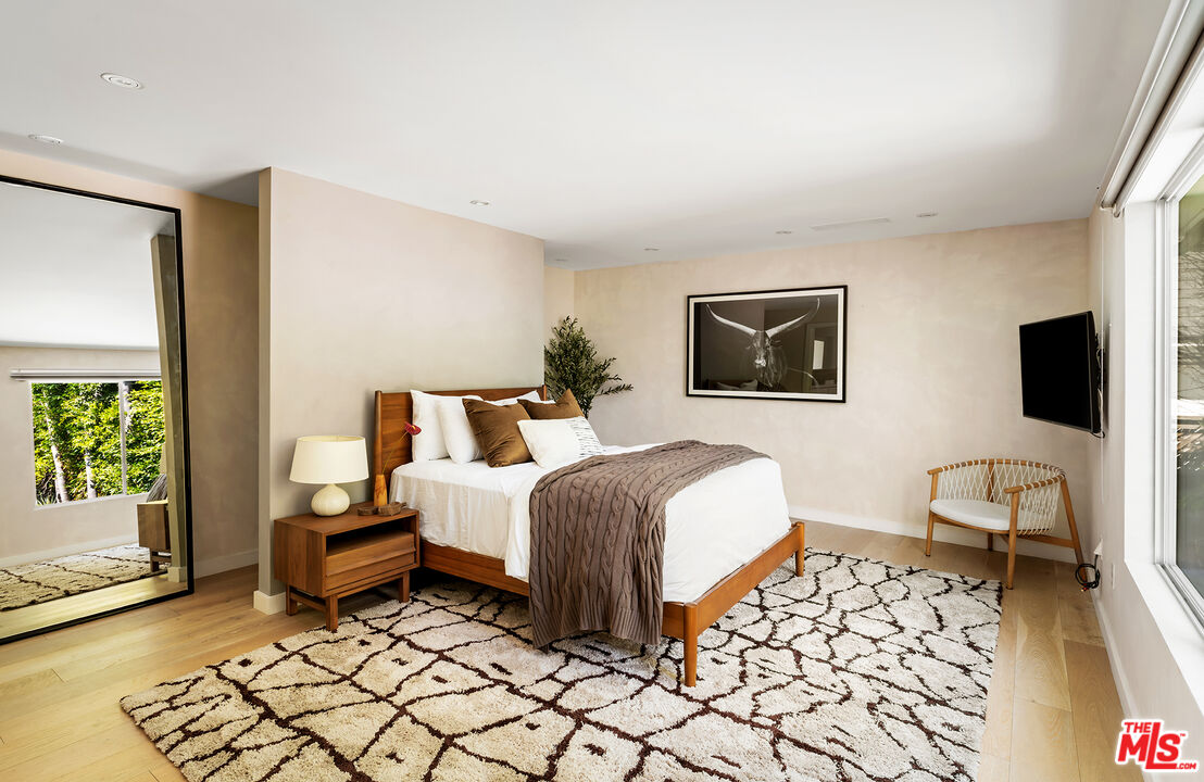 1600 North Kings Road Los Angeles, CA 90069 - Photo 22 of 37 a spacious bedroom with a bed and a couch
