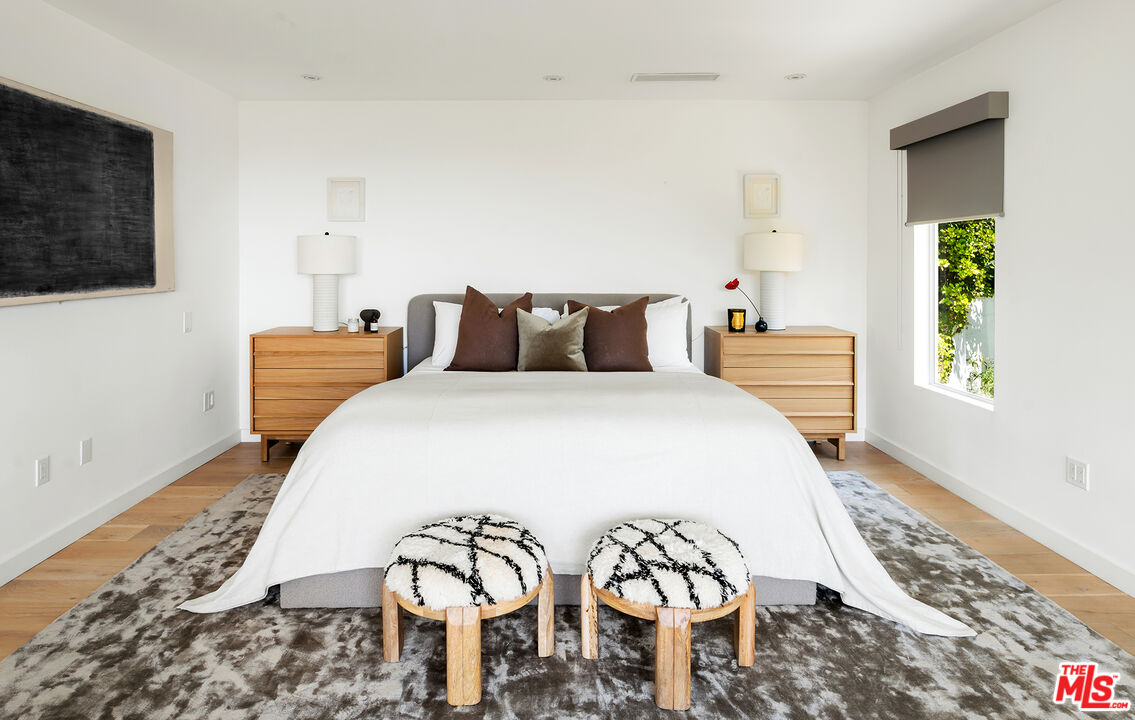 1600 North Kings Road Los Angeles, CA 90069 - Photo 26 of 37 a bedroom with a bed and wooden floor