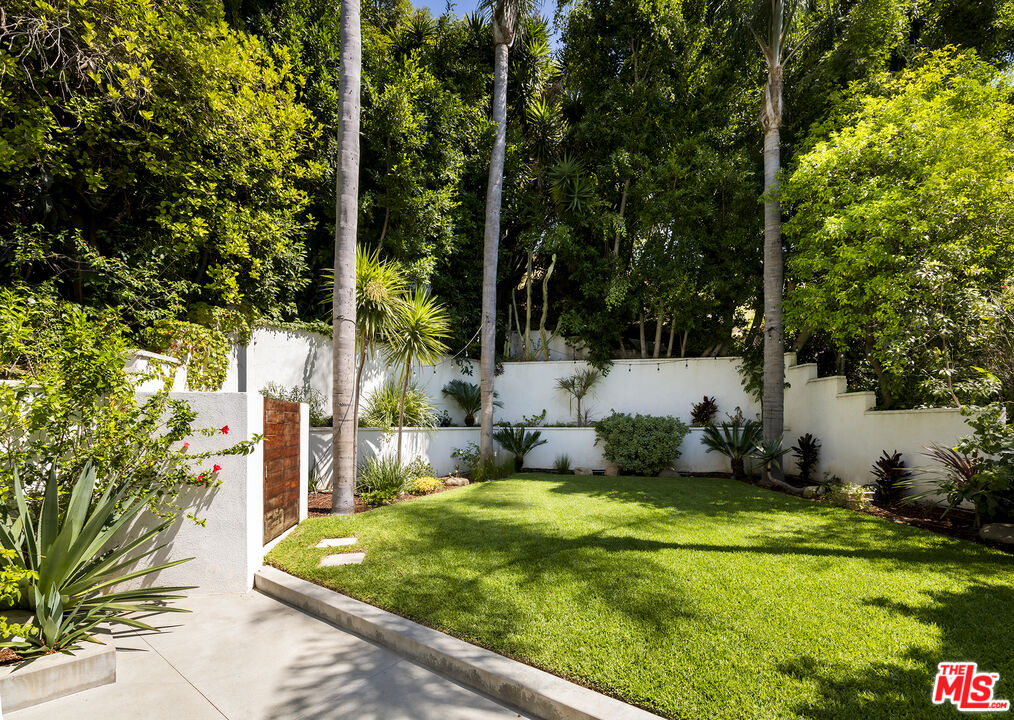 1600 North Kings Road Los Angeles, CA 90069 - Photo 34 of 37 a house with trees in front of it
