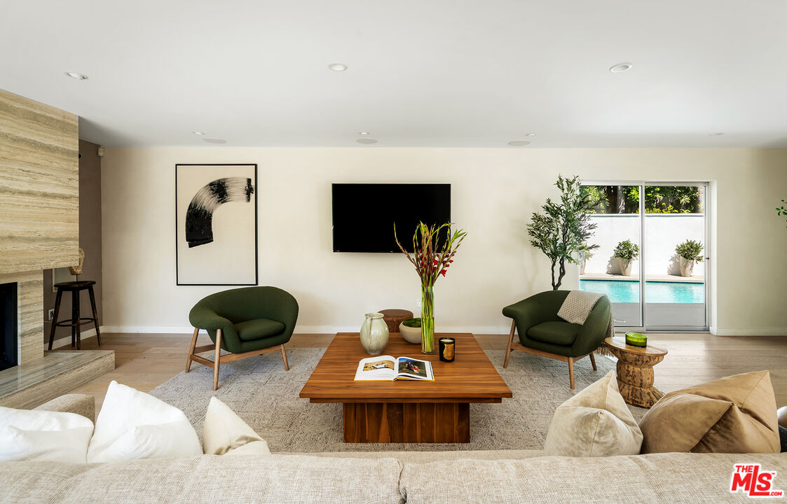 1600 North Kings Road Los Angeles, CA 90069 - Photo 5 of 37 a living room with furniture and a flat screen tv