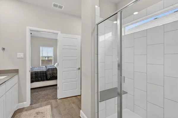 a bathroom with a glass door shower