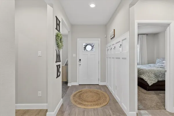 a view of a bedroom with a bed and wooden floor