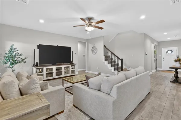 a living room with furniture and a flat screen tv