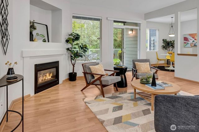 a living room with furniture a window and a fireplace