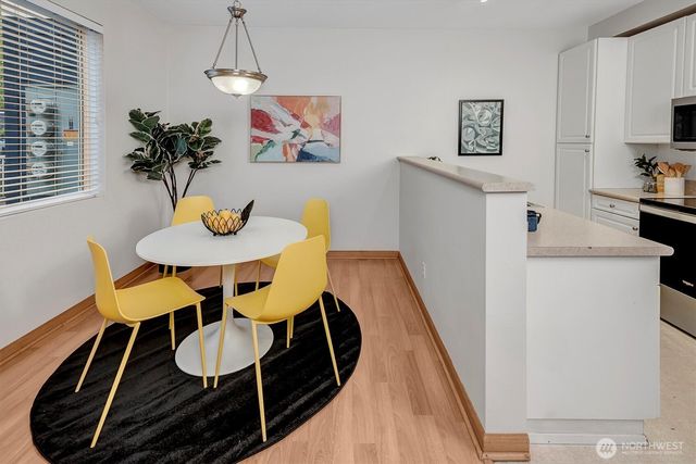 a view of a dining room with furniture and wooden floor