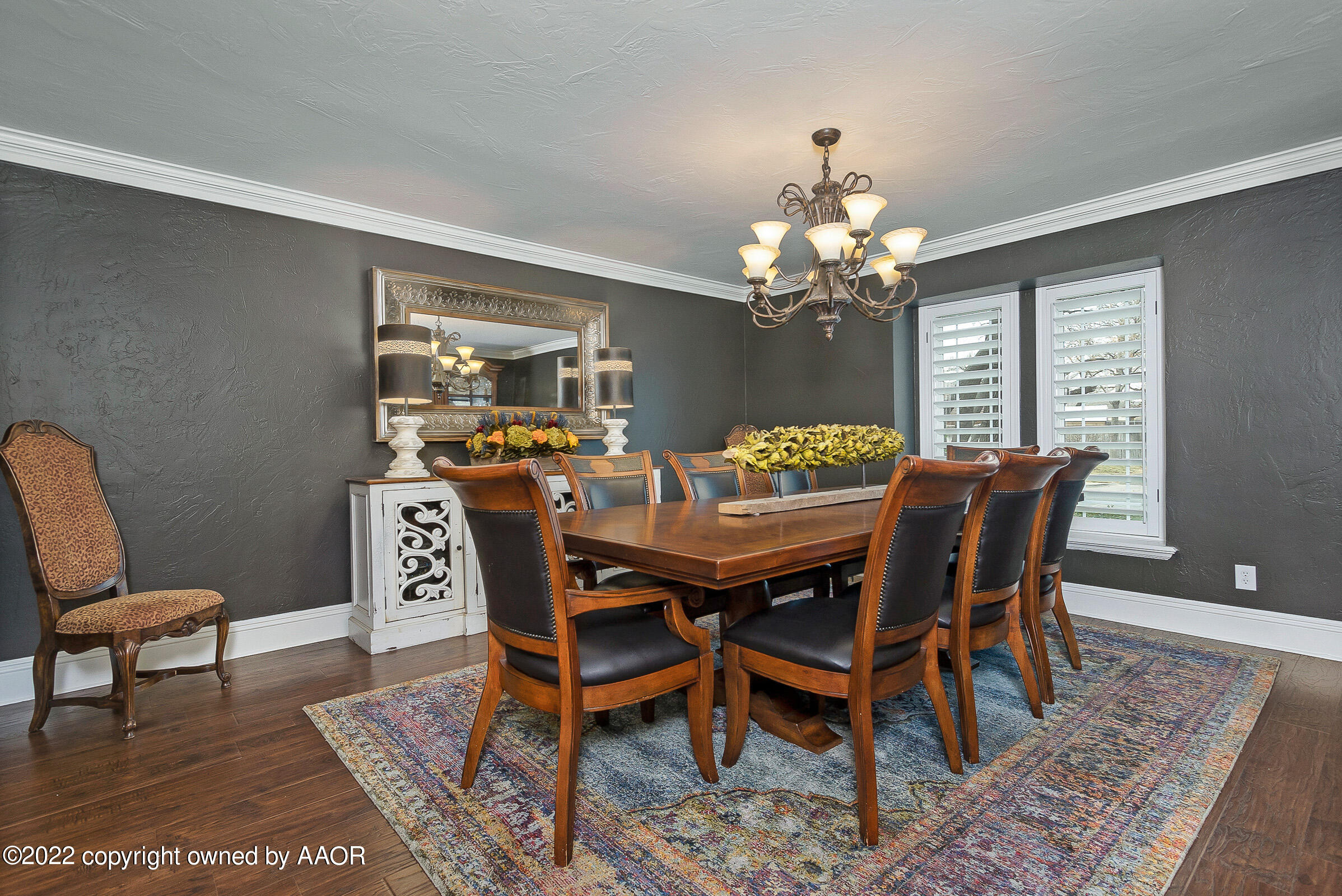 4223 Langtry Drive Amarillo, TX 79109 - Photo 11 of 56 a dining room with furniture a rug and a chandelier