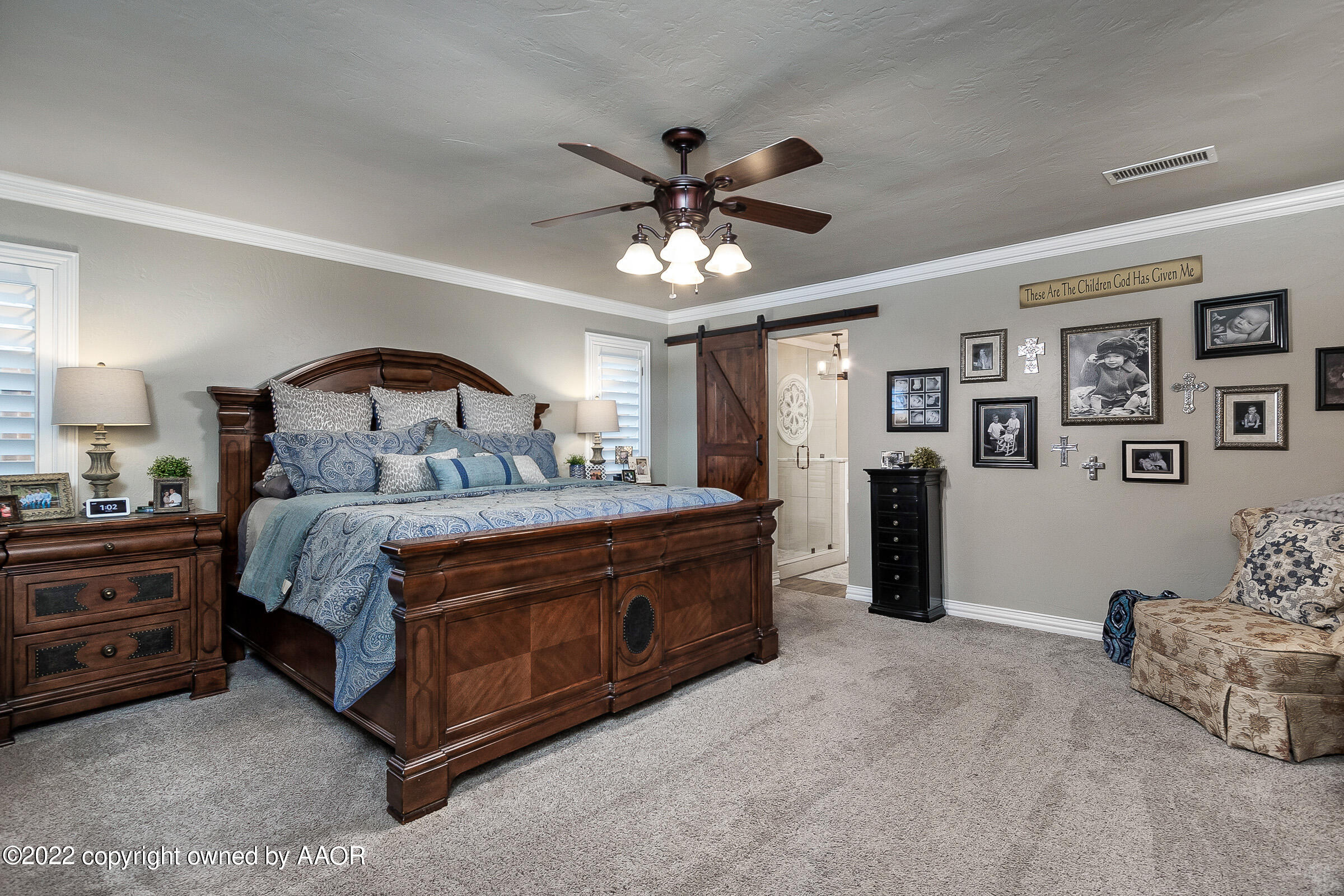 4223 Langtry Drive Amarillo, TX 79109 - Photo 12 of 56 a spacious bedroom with a bed and a chandelier