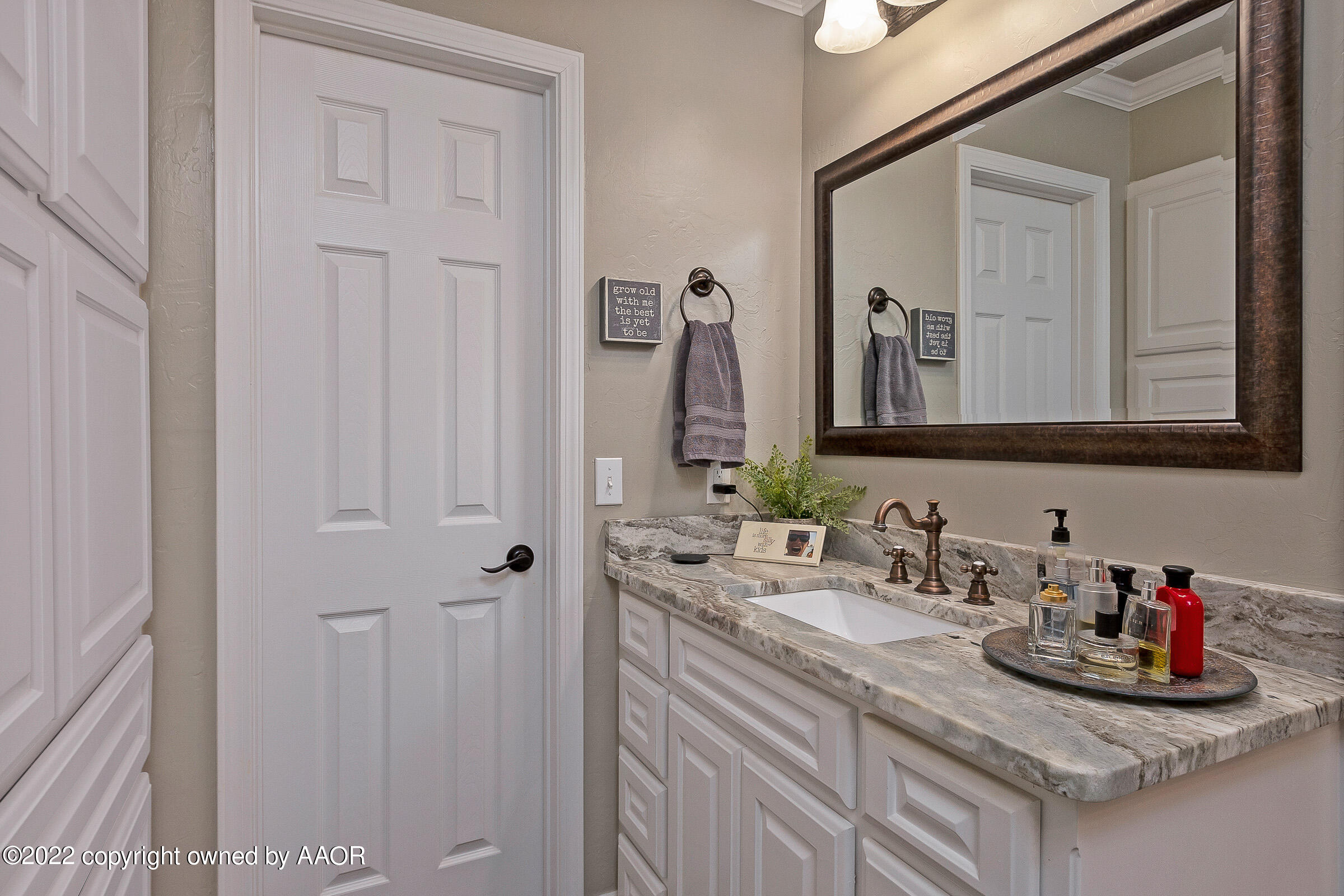 4223 Langtry Drive Amarillo, TX 79109 - Photo 15 of 56 a bathroom with cabinets and mirror