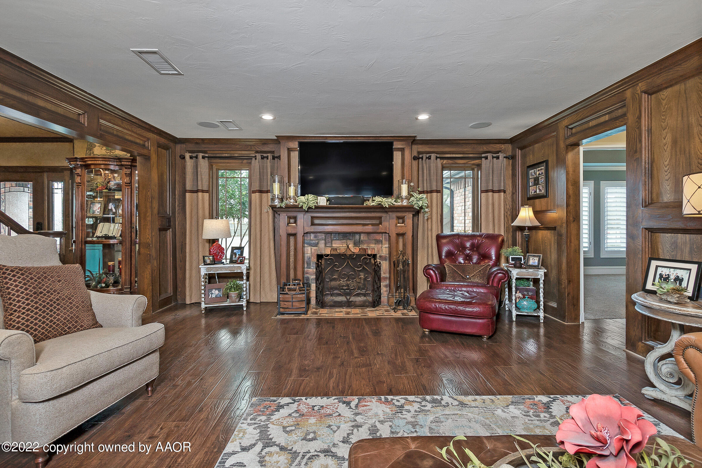 4223 Langtry Drive Amarillo, TX 79109 - Photo 23 of 56 a living room with furniture a flat screen tv and a fireplace