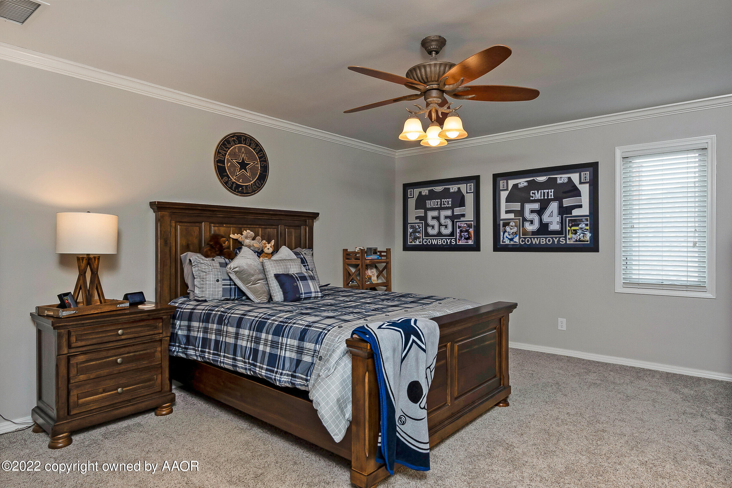 4223 Langtry Drive Amarillo, TX 79109 - Photo 38 of 56 a bedroom with a bed and a chandelier