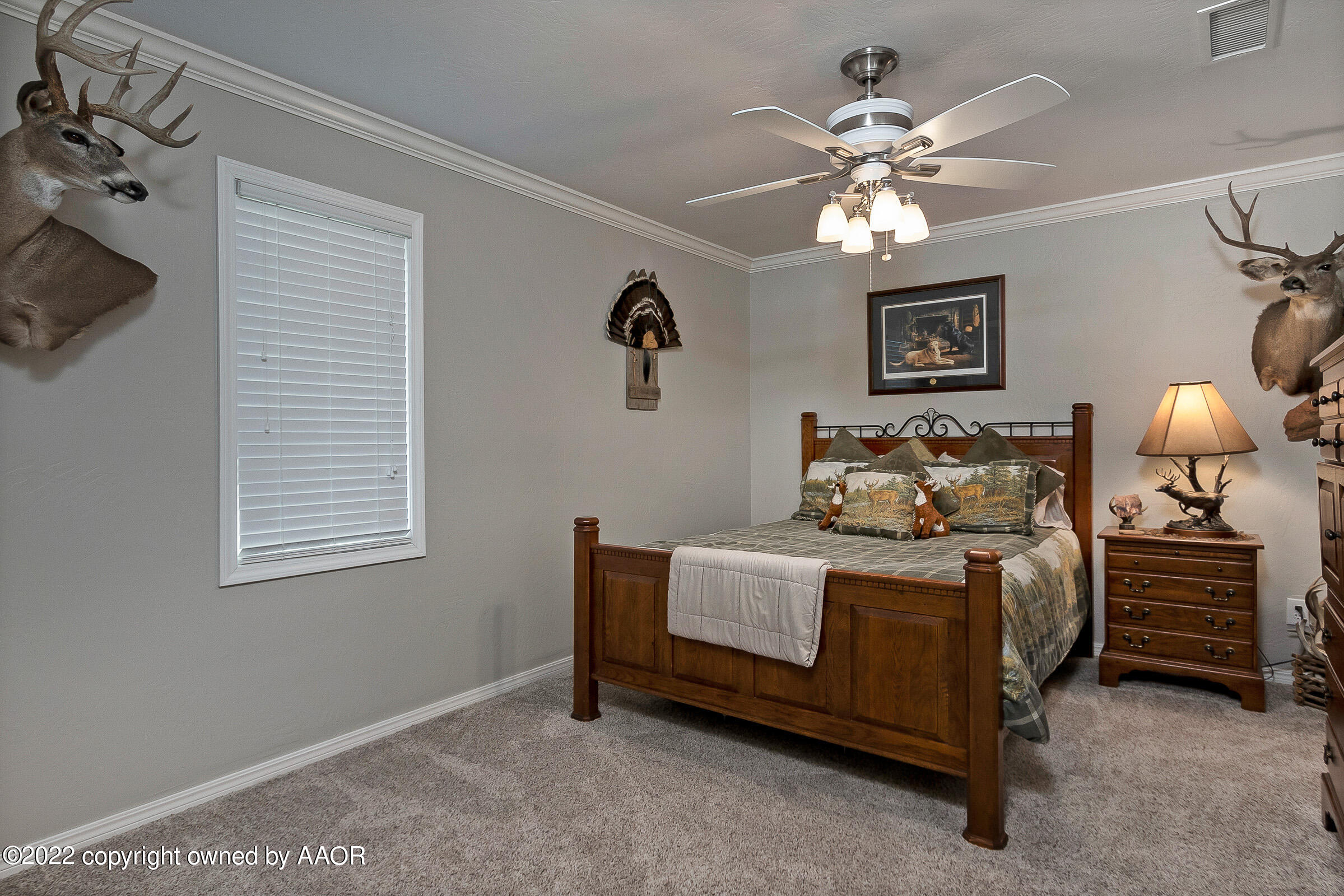 4223 Langtry Drive Amarillo, TX 79109 - Photo 40 of 56 a bedroom with a bed and a chandelier