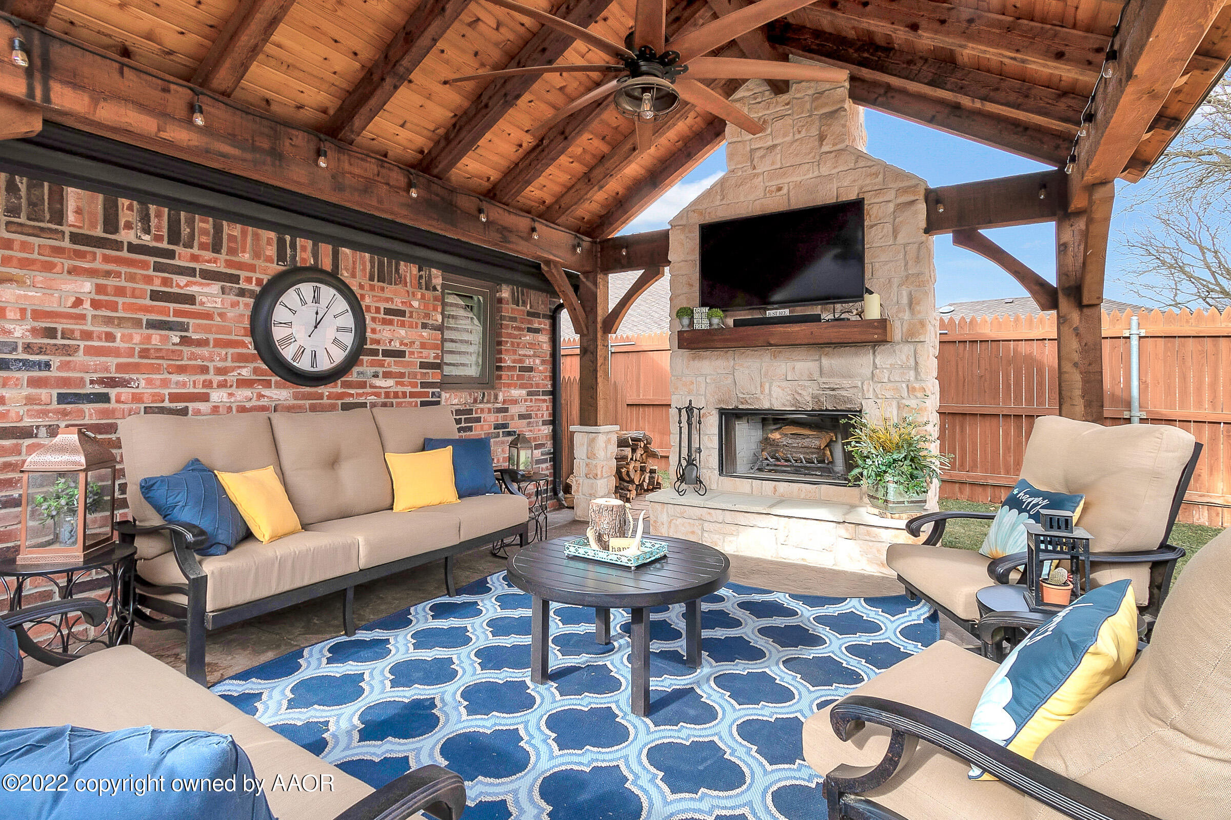 4223 Langtry Drive Amarillo, TX 79109 - Photo 46 of 56 a living room with furniture a fireplace and a flat screen tv