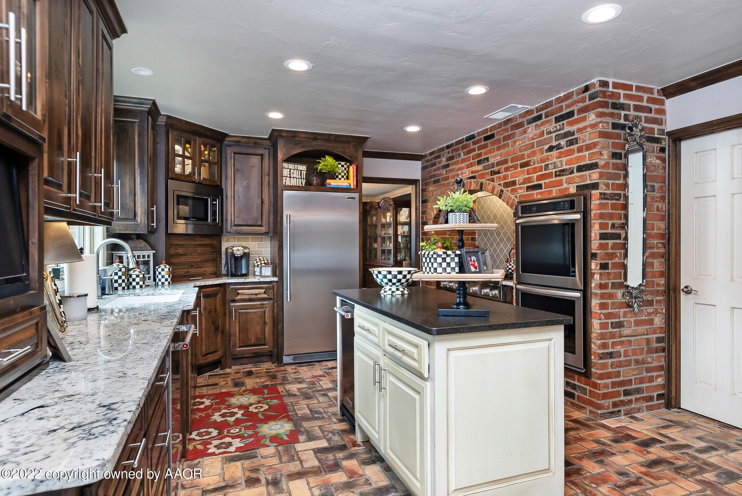 4223 Langtry Drive Amarillo, TX 79109 - Photo 5 of 56 a kitchen with granite countertop a sink and refrigerator