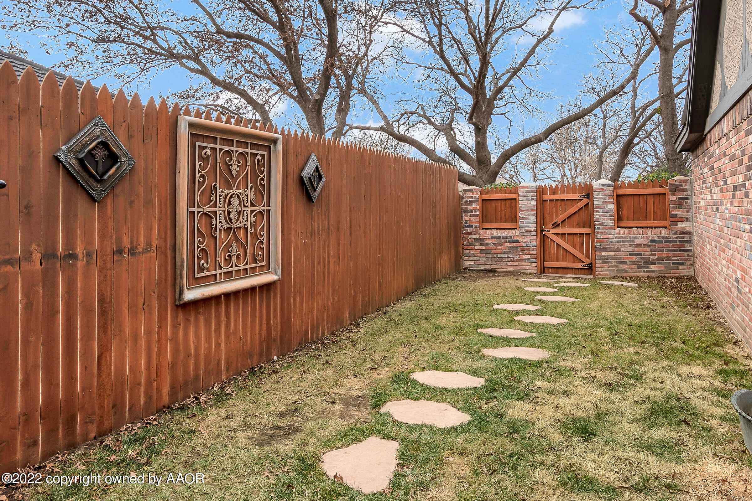 4223 Langtry Drive Amarillo, TX 79109 - Photo 53 of 56 a view of a brick wall with tree in front of it
