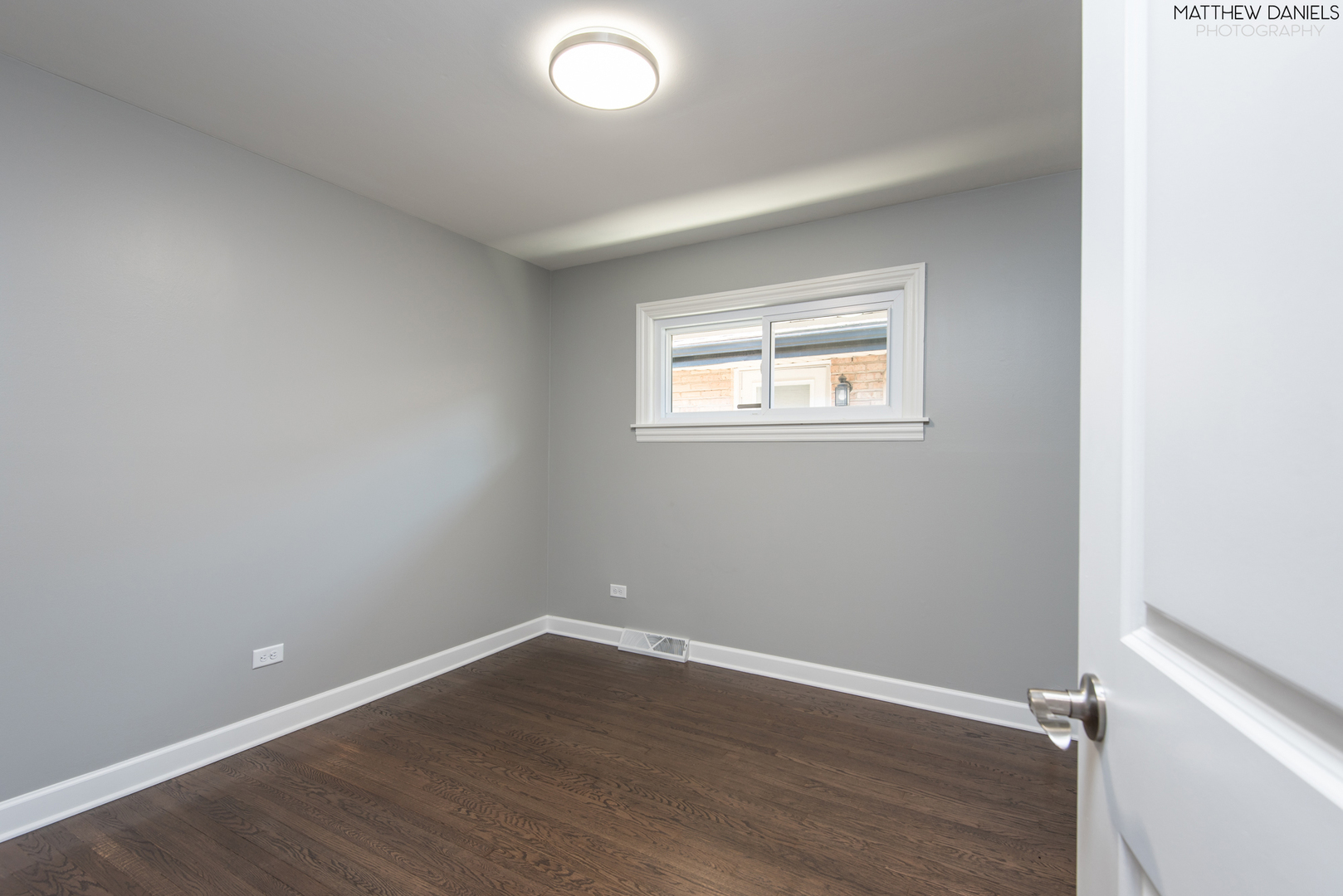 5208 State Road Burbank, IL 60459 - Photo 14 of 21 an empty room with wooden floor and windows