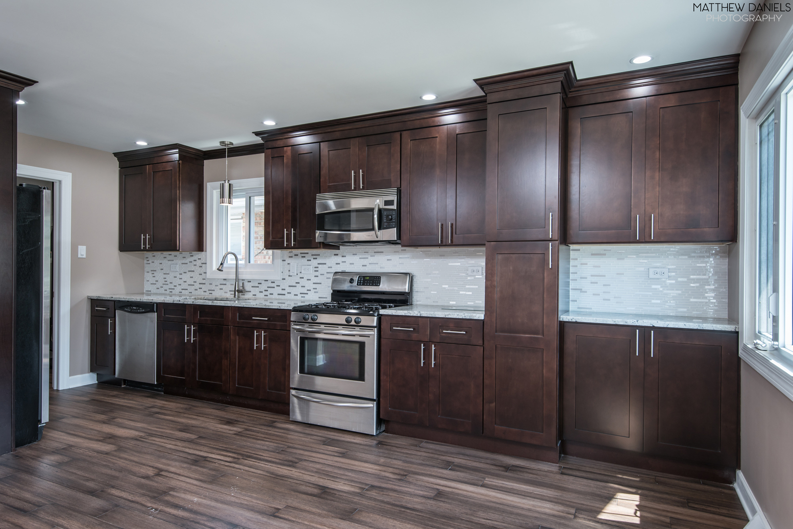 5208 State Road Burbank, IL 60459 - Photo 3 of 21 a large kitchen with stainless steel appliances granite countertop a stove a sink and a refrigerator
