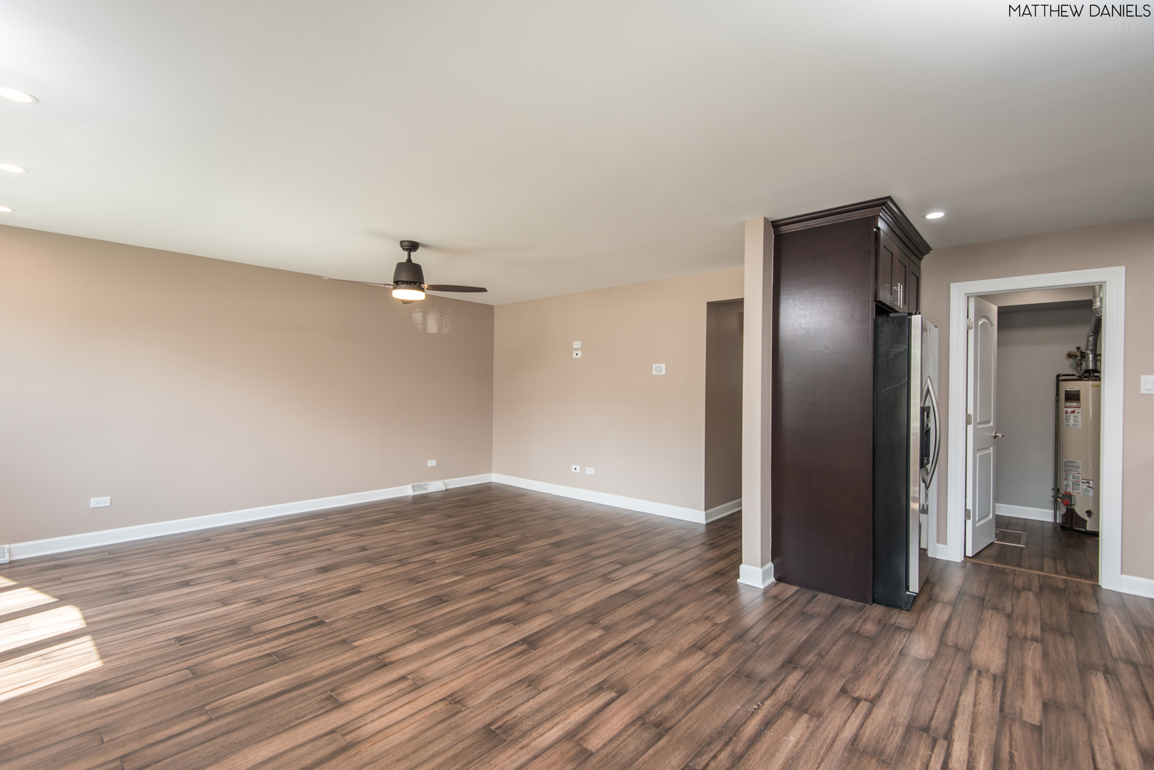 5208 State Road Burbank, IL 60459 - Photo 7 of 21 an empty room with wooden floor chandelier fan and windows